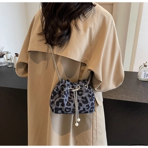 Detail of leopard print bucket bag with silver chain strap and pearl drawstring charms