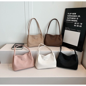 Group display of five large capacity pleated tote bags in neutral and pastel colors