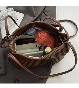 Interior view of brown pleated tote bag showing spacious storage for daily essentials