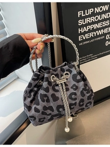 Fashionable cow print drawstring bucket bag with silver metal ring handle and pearl charms