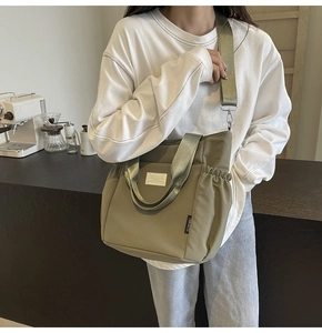 Detailed side pocket and nylon fabric texture of the olive green crossbody shoulder bag