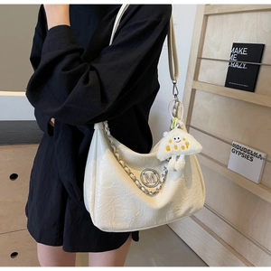 Detail of cream pleated leather shoulder bag with silver M logo and fluffy cloud charm