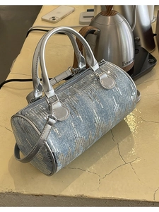 Chic blue denim cylinder bag with silver sequins and metallic straps for women