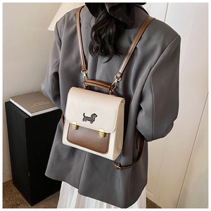 Detail of a mini two-tone backpack with dachshund embroidery and gold vintage buckles