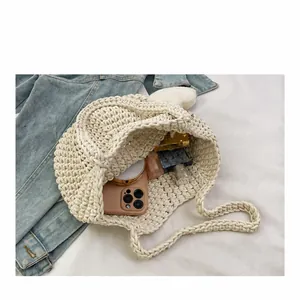 Close-up of hand-woven crochet tote bag showing spacious interior with personal items