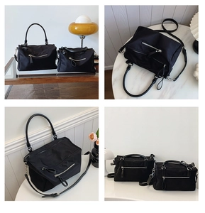 Detail view of black nylon bags in two sizes with silver hardware and geometric folding design