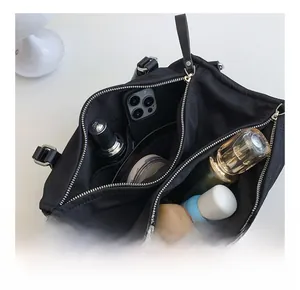 Internal compartments of black nylon crossbody bag showing storage capacity