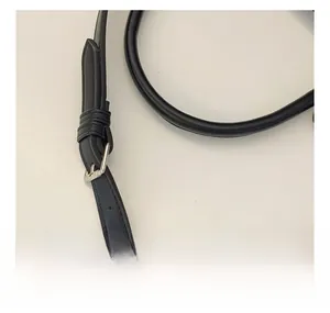 Detail of the adjustable black nylon bag strap with a silver metallic buckle closure