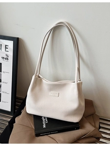 Minimalist beige corduroy tote bag with vintage texture and sleek shoulder strap