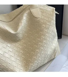 Macro shot of beige woven leather texture and premium stitching on the tote travel bag