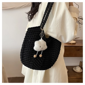 Detail of black crochet shoulder bag featuring a thick rope weave and cloud charm