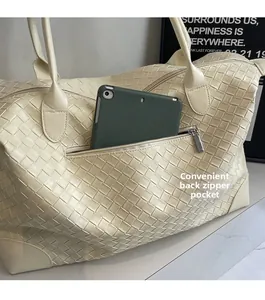 Detail of woven tote bag back zipper pocket for easy tablet storage and travel