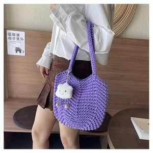 Detail of purple hand-woven crochet hobo bag with cute white cloud plush pendant