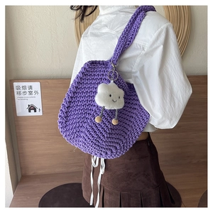 Detail of purple hand-woven crochet shoulder bag with cute cloud plush charm