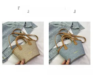 Detail of khaki and blue canvas bucket bags with leather straps and texture focus