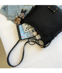 Detailed interior view showing large storage capacity of black leather bucket bag