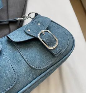 Nahaufnahme der Jeans-Schultertasche mit silbernen Schnallen und Nietendetails