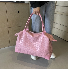 Close-up of pink woven leather tote bag showing intricate craftsmanship and texture