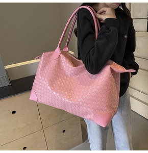 Detailed view of pink woven tote bag with large capacity for travel and daily use