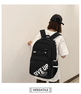 Back view of a large black backpack with SUNT lettering and globe graphics on a model