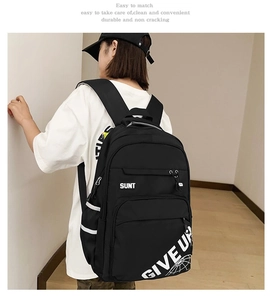 Close-up of durable black canvas backpack featuring SUNT logo and reflective side straps
