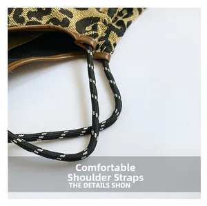 Close-up of leopard print tote bag featuring woven rope straps and leather trim detail