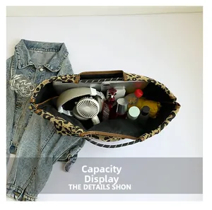 Top view of spacious leopard print tote bag showing large interior capacity with essentials