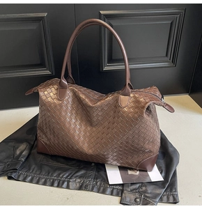 Detail of dark brown woven tote bag showing large capacity and textured leather craftsmanship