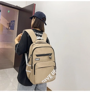 Detail view of khaki backpack with SUNT logo and GIVE UP print in a spacious design