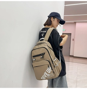 Detail showing khaki oxford backpack with GIVE UP letter print and side storage pocket
