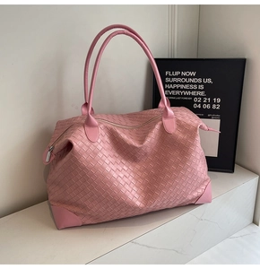 Detail of pink woven large tote bag featuring reinforced corners and secure zip closure