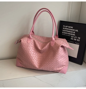 Close-up of pink woven leather tote bag showing intricate craftsmanship and large capacity