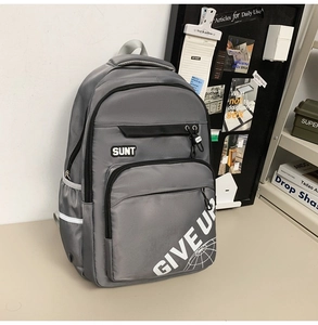 Detail of grey student backpack with SUNT print, zipper pockets and reflective strips
