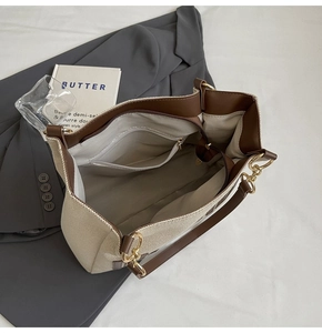 Top-down view of spacious tote bag interior with zipper pocket and beige woven lining