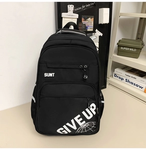 Close-up of black backpack featuring reflective GIVE UP text and mesh side pocket detail