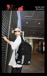 Detailed view of black large-capacity trendy backpack with white SPECIAL lettering print
