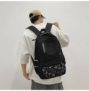 Close-up of black backpack featuring racing text straps and ergonomic padded shoulders