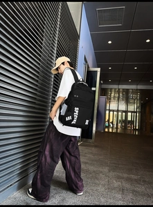 Street style black backpack featuring bold white 'ARE SPECIAL' print and mesh side pocket
