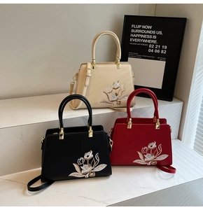 Detailed close-up of vintage tote bags with floral embroidery and golden hardware accents