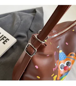 Detail of silver metal buckle and brown leather strap on the cartoon hamburger tote bag