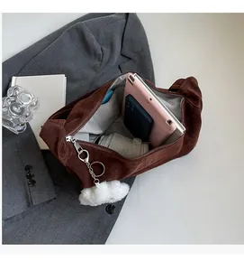 Detailed view of the large capacity interior of this dark brown suede shoulder bag