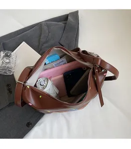 Spacious interior of brown leather tote bag with zip pocket showing high capacity storage