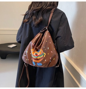 Detail of cute burger backpack with adjustable straps and cartoon print for daily use