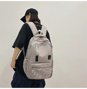 Detailed back view of light grey backpack featuring ergonomic padded shoulder straps