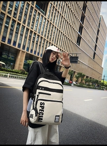 Detail of stylish black and white backpack with SPECIAL lettering and mini coin purse