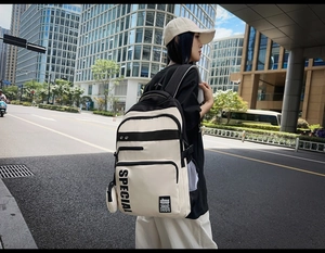 Close-up of minimalist two-tone backpack with mesh pocket and SPECIAL lettering detail