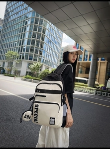 Outdoor shot of the bicolor backpack with SPECIAL print and small side pouch detail