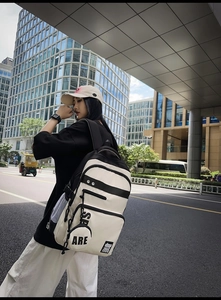Close-up of a high-capacity black and white patchwork backpack with stylish SP logo lettering