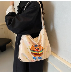Side view of a cream PU leather tote bag with a cute cartoon burger print and graphics