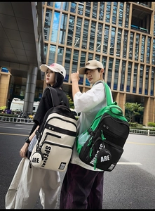 Detail of trendy high-capacity backpack with contrast stitching and mini coin pouch hanging
